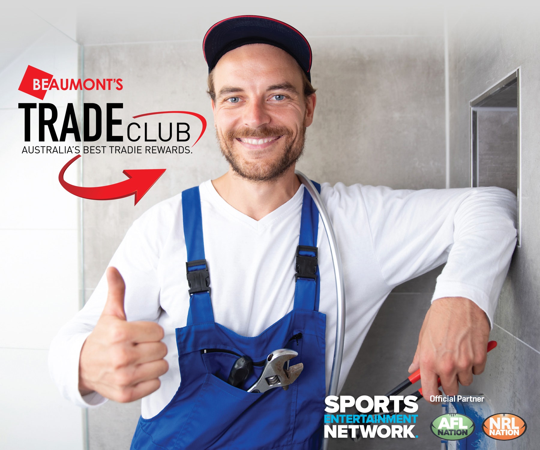 A tradie smiling thumbs up with an over all and a hat promoting Beaumont Tiles Trade Club