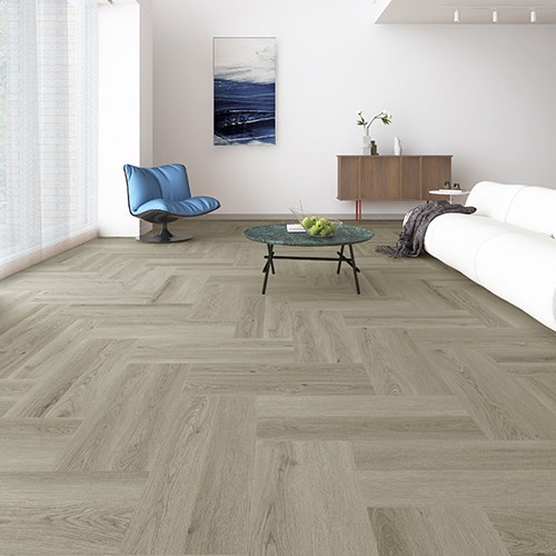 Modern living room featuring Charm Grey Oak Herringbone SPC Core hybrid flooring in a cool-toned timber look.