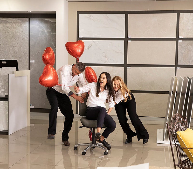 Beaumont Tiles store inside, glossy floor tiles, tiles on display a complete bathroom package display and Beaumont Tiles team members having fun