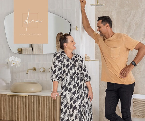 Deb and Andy share smiles in the beautifully designed bathroom of their Beaumont Tiles-adorned house