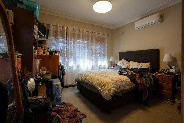 A master bedroom full of clutter